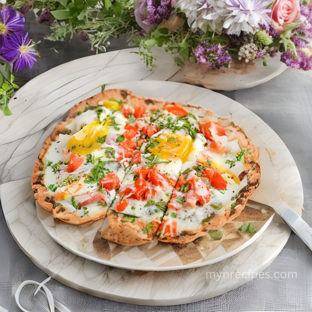 Pita Pizza A Healthy Breakfast Powerhouse Craving a breakfast that's both healthy and delicious, ready in a flash? Look no further than this recipe one-pan wonder! Here's what you'll need Why you'll love this recipe Forget sugary cereals and greasy breakfast sandwiches! This recipe for Crispy Flatbread Baked Eggs with Sun-Kissed Tomatoes is your ticket to a healthy and delicious start to your day. Let's break down why it's a nutritional champion: Each serving packs a satisfying protein duo with 2 eggs and mozzarella cheese. Protein keeps you feeling fuller for longer, preventing mid-morning crashes and cravings. The tomatoes explode with vitamins A, C, and K, essential for healthy vision, immunity, and blood clotting. Baby spinach adds a boost of iron, folate, and vitamin K, crucial for energy production and cell growth. Whole wheat flatbread provides fiber, aiding digestion and promoting gut health. This keeps you feeling regular and energized throughout the morning. Mozzarella cheese offers a dose of healthy fats, supporting cell function and hormone production. Plus, it adds creaminess and flavor without overloading on saturated fat. Quick & Easy: Ready in just 10 minutes, this recipe is perfect for busy mornings when you need a nutritious breakfast but are short on time. So ditch the unhealthy breakfast rut and prepare this recipe! It's a delicious and nutritious way to fuel your day and feel your best from . About Time: Prep Time: 10 mins Cook Time: 10 mins Total Time: 20 mins Yield: 1 Serves Syn Free Keywords: flatbread, baked eggs, tomatoes, spinach, mozzarella, healthy breakfast, quick and easy, one-pan meal, vegetarian, low-carb, family-friendly, customizable Ingredients: 1 Flatout flatbread (or your favorite whole wheat tortilla) - the base for our masterpiece 25g mozzarella cheese - shredded for melty goodness 2 eggs 2 small ripe tomatoes, chopped few baby spinach leaves Fresh herbs (parsley, coriander, or basil) - a final flourish of fragrance (optional) Salt and pepper - to taste Instructions: Preheat your oven to 200°C (400°F) - let it get and toasty while you prep. Line a baking tray with parchment paper Unfurl your flatbread (or tortilla) onto the prepared tray Scatter a handful of baby spinach over the flatbread - a bed of greens for your delicious toppings, Scatter with chopped tomatoes Carefully crack two eggs on top, aiming for even distribution - yolks nestled amongst the toppings. Sprinkle with the grated mozzarella Season with salt and black pepper (Optional) Garnish with your chosen fresh herbs Place in the oven and bake for approx 10 minutes until egg is cooked but yolk still soft and flatout (or tortilla) is lightly golden/crisp. Slice and enjoy!! Tip: Swap the mozzarella for goat cheese for a tangy twist. Add crumbled cooked bacon or sausage for a heartier option. Drizzle with hot sauce for a spicy kick. Use roasted vegetables, leftover cooked meats, or your favorite cheese blend. Preheat your baking sheet in the oven before adding the flatbread. This jumpstarts the crisping process Roast the tomatoes beforehand for smoky caramelized notes. This recipe is already a breakfast winner